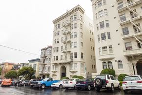 San Francisco apartment for rent - A row of cars are parked in front of a building.