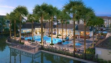 Bradenton apartment for rent - an aerial view of a resort with a pool and palm trees