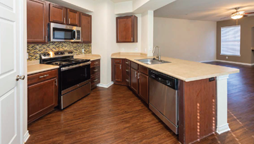 Shreveport apartment for rent - A kitchen with wooden cabinets and a white countertop.