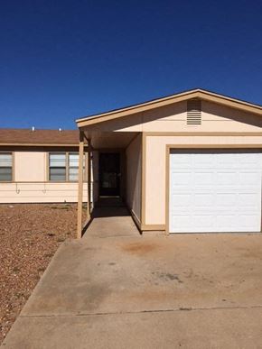 Snyder house for rent - a house with a white garage door and a driveway