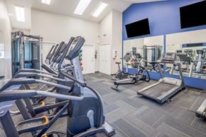 Toledo townhouse for rent - a gym with cardio machines and weights at the monarch apartments in midtown