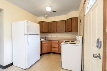 Canton apartment for rent - a kitchen with white appliances and wooden cabinets and a white refrigerator