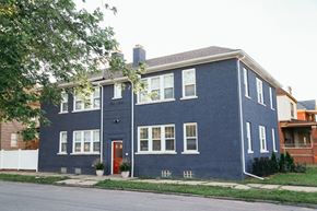Detroit apartment for rent - a blue house with white windows and a red door