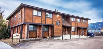 Colorado Springs apartment for rent - A brown wooden building with a sign that says "REACH".