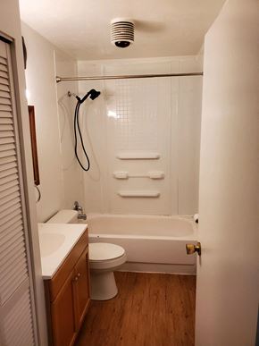 Wadsworth apartment for rent - A white bathroom with a toilet, sink, and tub.