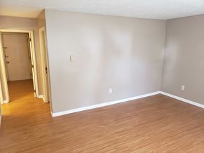 Wadsworth apartment for rent - A room with a wooden floor and a door on the left.