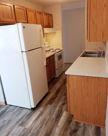Buffalo apartment for rent - an empty kitchen with a refrigerator and a sink