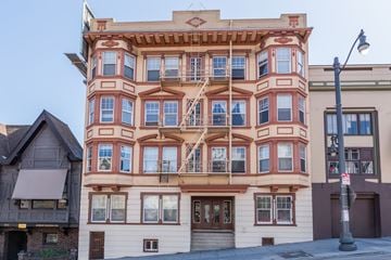 San Francisco apartment for rent - A tall building with many windows and balconies is seen in the image.