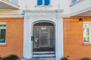 San Francisco apartment for rent - A red brick building with a white door and windows.