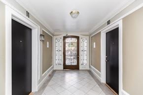 San Francisco apartment for rent - A hallway with black doors and a white tiled floor.