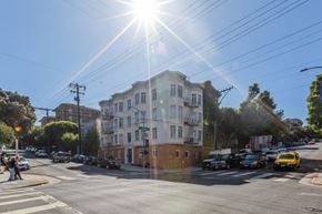 San Francisco apartment for rent - A sunny day in a city street with cars and a yellow taxi.