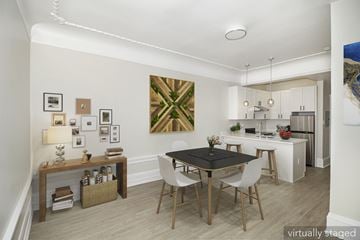 San Francisco apartment for rent - A dining room with a black table and white chairs.