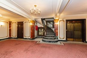San Francisco apartment for rent - A grand staircase with a red carpeted floor and gold accents.