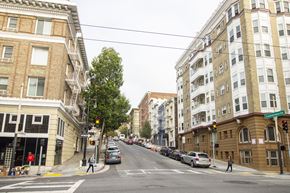 San Francisco apartment for rent - A street scene with cars and buildings on either side.