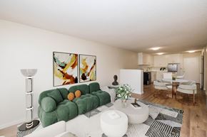 Oakland apartment for rent - A living room with a green couch and a painting on the wall.