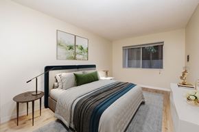 Oakland apartment for rent - A bedroom with a bed, nightstand, and lamp.