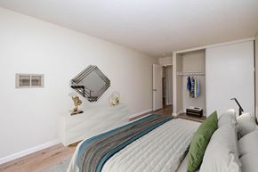 Oakland apartment for rent - A bedroom with a large bed and a mirror on the wall.