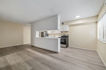 Oakland apartment for rent - A kitchen area with a white countertop and a microwave above it.