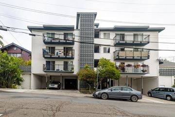 Oakland apartment for rent - A modern apartment building with a car parked in front.