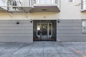 San Francisco apartment for rent - A building with a black gate and a small plant on the gate.