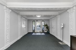 San Francisco apartment for rent - A hallway with white walls and a grey carpet.