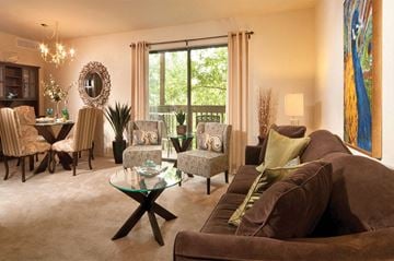 Essex apartment for rent - A living room with brown couches and a glass coffee table.