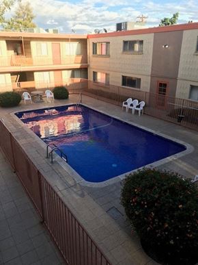 Tucson apartment for rent - a large swimming pool in front of a building