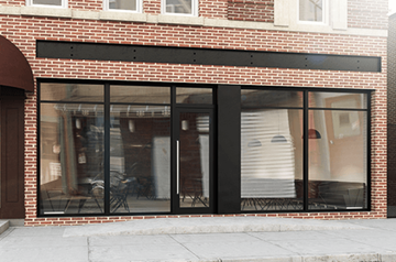Brooklyn apartment for rent - a brick storefront with glass windows and a black facade
