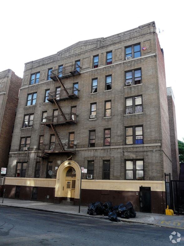 The Bronx apartment for rent - a building with a fire escape on the side of a street