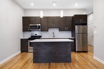 Chicago apartment for rent - a modern kitchen with stainless steel appliances and wooden cabinets