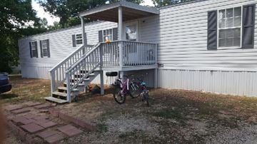 Laurens house for rent - A bicycle is parked in front of a house.