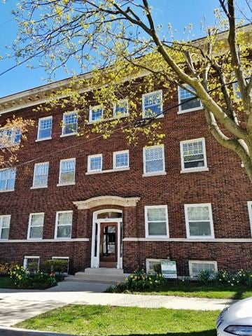 Milwaukee apartment for rent - a red brick building with a tree in front of it