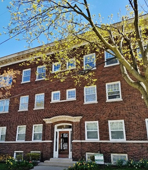 Milwaukee apartment for rent - a red brick building with a tree in front of it