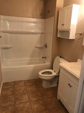 Arkadelphia apartment for rent - A white toilet with a white bathtub and sink in a bathroom.