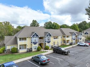 Hickory apartment for rent - A car is parked in a parking lot in front of a building.
