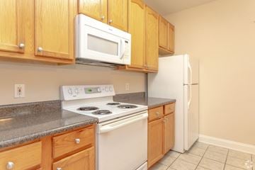 Hickory apartment for rent - A kitchen with a stove, microwave, and refrigerator.