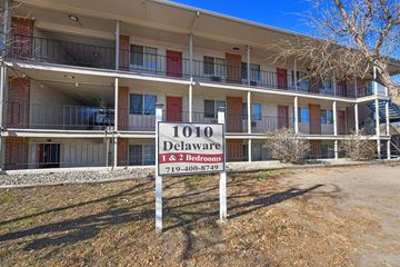 Colorado Springs apartment for rent - A sign for Delaware 1 & 2 Bedrooms stands in front of a building.