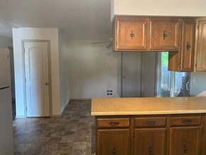Sandpoint house for rent - an empty kitchen with a counter top and cabinets