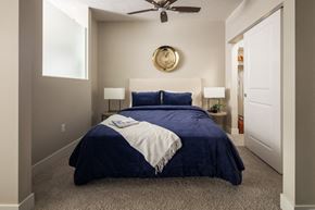 Omaha apartment for rent - a bedroom with a bed and a ceiling fan