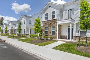 Whitehouse Station apartment for rent - a row of white houses with a sidewalk and grass