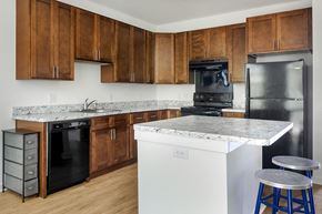 Whitehouse Station apartment for rent - a kitchen with marble counter tops and black appliances