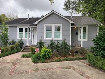 Baton Rouge house for rent - a gray house with green shutters and a stop sign