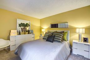 Woodland Hills apartment for rent - a bedroom with a large bed and yellow walls