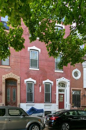 Philadelphia apartment for rent - a red brick building with cars parked in front of it