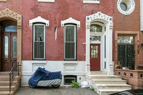 Philadelphia apartment for rent - a truck parked in front of a red brick house