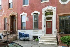 Philadelphia apartment for rent - the front of a brick house with a red door