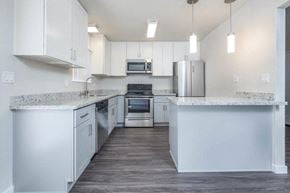 Manteca apartment for rent - Alternate view of kitchen with stone counters, white cabinets, stainless appliances