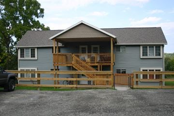Ithaca apartment for rent - a house with a deck and a fence in front of it