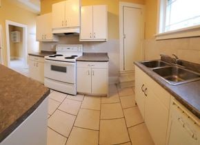 Brandon apartment for rent - a kitchen with white appliances and white cabinets