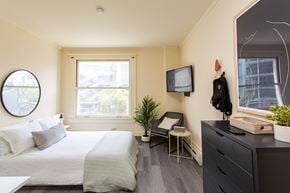 Brooklyn apartment for rent - a bedroom with a bed and a dresser and a window